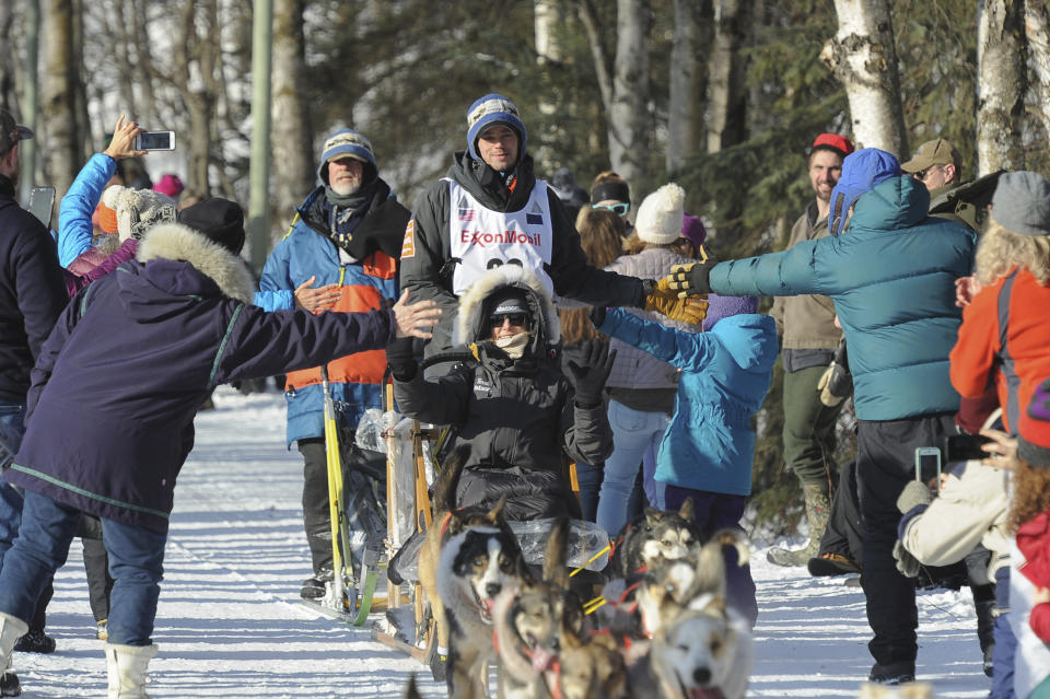 Defending Iditarod champion Joar Lefseth Ulsom, of Norway, greets fans on the trail during the ceremonial start of the Iditarod Trail Sled Dog Race Saturday, March 2, 2019 in Anchorage, Alaska. (AP Photo/Michael Dinneen)