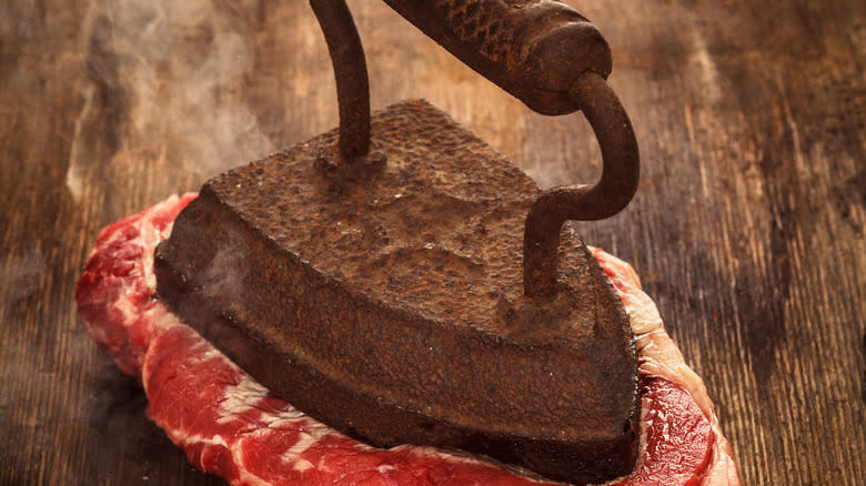 Grill press on beef