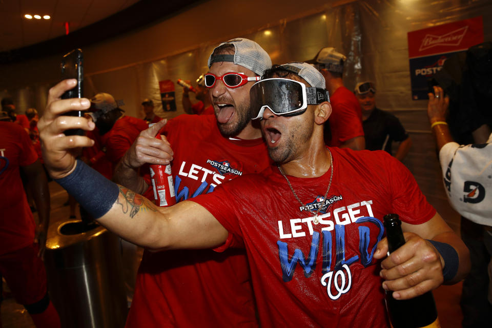 Washington Nationals starting pitcher Max Scherzer, left, and Gerardo Parra celebrate after the second baseball game of a doubleheader against the Philadelphia Phillies, Tuesday, Sept. 24, 2019, in Washington. Washington won 6-5 and clinched a Wild Card berth. (AP Photo/Patrick Semansky)