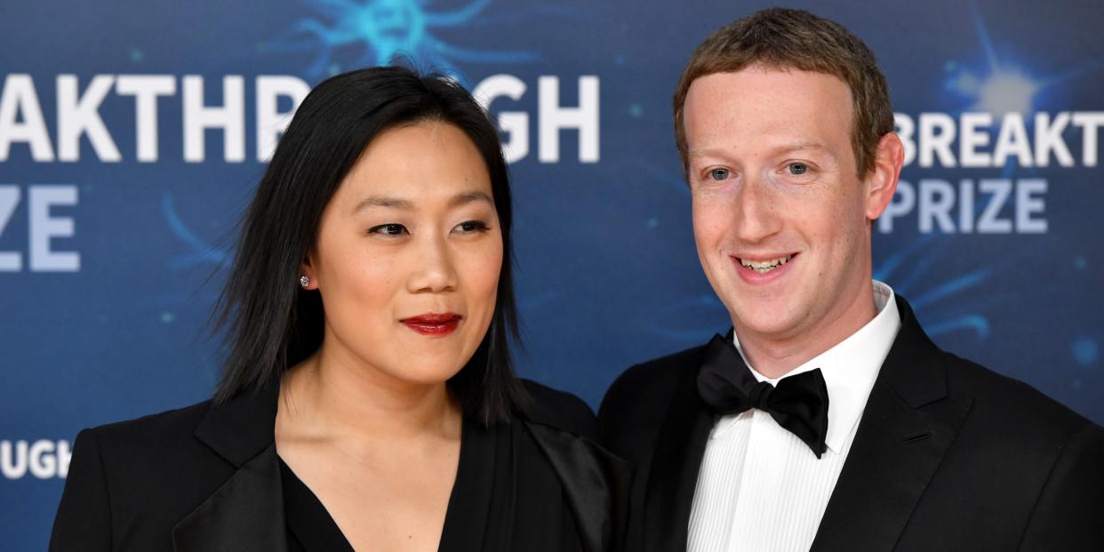 Priscilla Chan and Mark Zuckerberg stand side-by-side in formal dress at an awards show in 2019