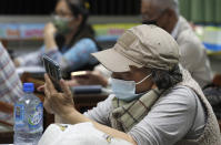 Students of Fake News Cleaner learn how to use the LINE app to identify fake news during a class in Kaohsiung City, southern Taiwan, Thursday, March 16, 2023. An anti-misinformation group in Taiwan called Fake News Cleaner has hosted more than 500 events, connecting with college students, elementary-school children — and the seniors that, some say, are the most vulnerable to such efforts. (AP Photo/Chiang Ying-ying)