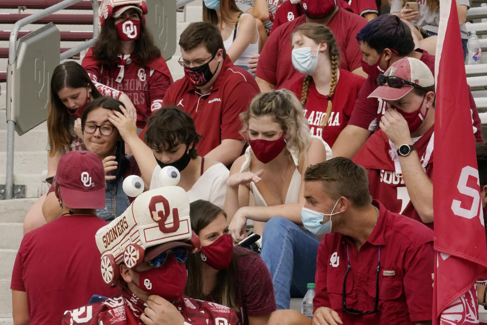 FILE - In this Saturday, Sept. 12, 2020 file photo, fans in the student section are pictured before an NCAA college football game between Missouri State and Oklahoma, in Norman, Okla. To achieve greater compliance with the University of Oklahoma's COVID-19 policies, the university's Athletics Department is announcing additional measures that will be implemented for the next home football game. (AP Photo/Sue Ogrocki, File)