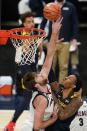 West Virginia's Gabe Osabuohien (3) shoots against Gonzaga's Drew Timme, left, during the first half of an NCAA college basketball game Wednesday, Dec. 2, 2020, in Indianapolis. (AP Photo/Darron Cummings)