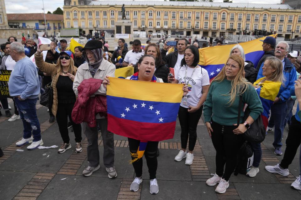 Supporters of opposition leader María Corina Machado sing their national anthem during a protest demanding free and fair elections in Venezuela's upcoming election, in Bolivar Square in Bogota, Colombia, Saturday, April 6, 2024. (AP Photo/Fernando Vergara)