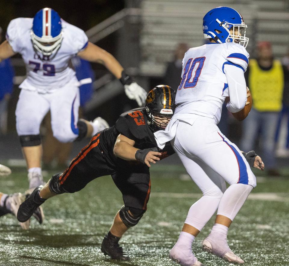 Green defender Michael Schaal sacks Lake quarterback Noah Kubasky in the second half at Green Friday, October 20, 2023.