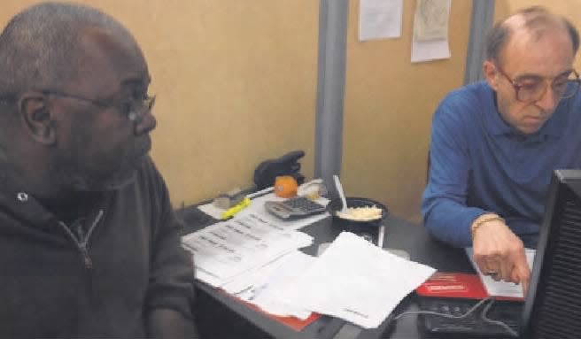 Wilbur Banks of Plainfield (left) had his last-minute tax return done by Mark R. Savitt with Jackson Hewitt Tax Service in Piscataway.