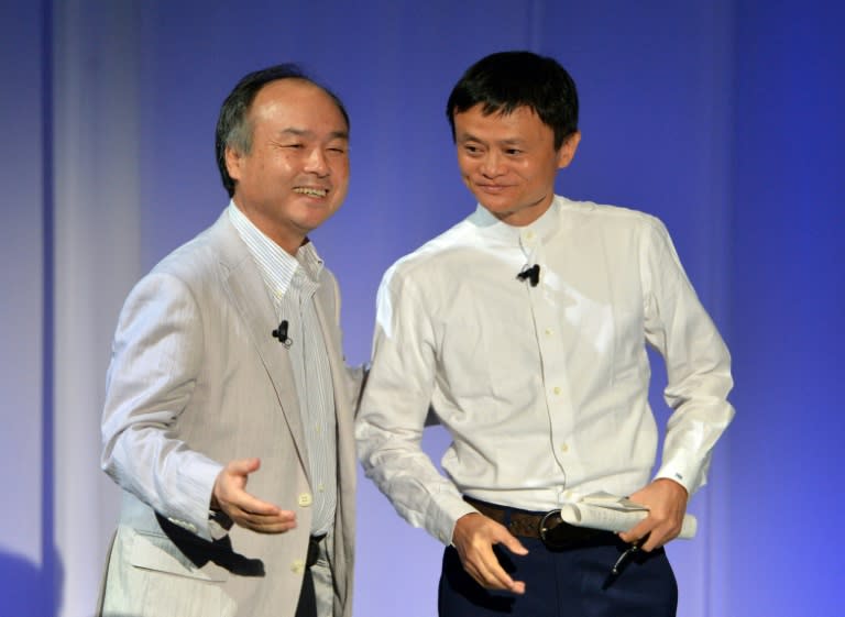 Masayoshi Son, left, who leads the Japanese mobile carrier, and Alibaba's executive chairman Jack Ma, pictured in 2014, will each remain on the board of the other's firms