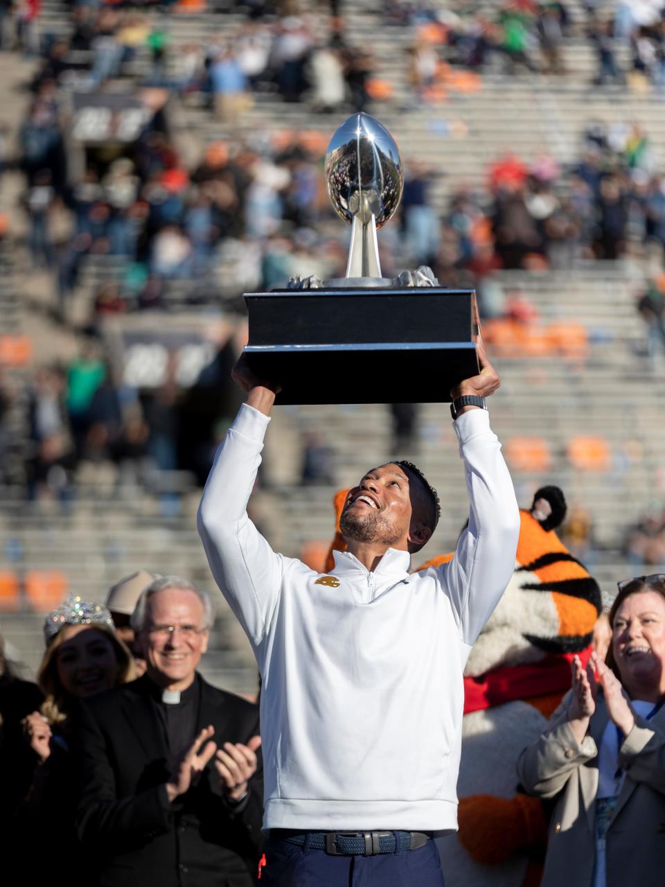 Notre Dame head football coach Marcus Freeman lifts the trophy, celebrating his 40-8 win against Oregon State in the 90th annual Sun Bowl game on Friday, Dec. 29, 2023, at El Paso, Texas.
