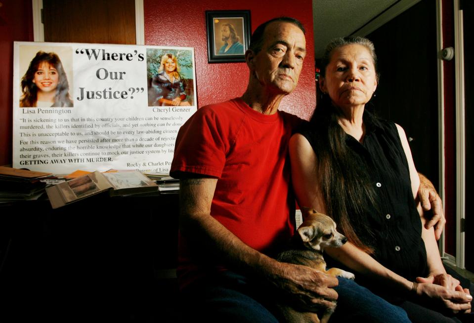 Rocky Pennington and his wife, Charlette Pennington, pose for a photo Sept. 19, 2007, at their home in El Reno, with a sign about the case of their daughters, Lisa Pennington and Cheryl Genzer, who were killed after disappearing from the state fair in 1987. The two have since passed away, never finding answers in the case.
