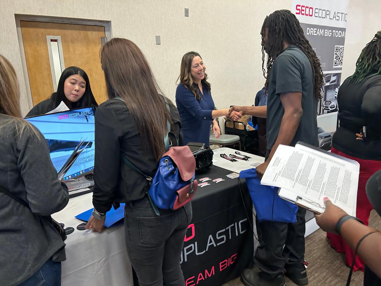 Sabrina Vasher, director of human resources at Ecoplastic America Corp., greets an applicant during Worksource Georgia's Hyundai Motor Group Metaplant America and supplier job fair on April 4, 2024 at Savannah Technical College's Eckberg Auditorium.