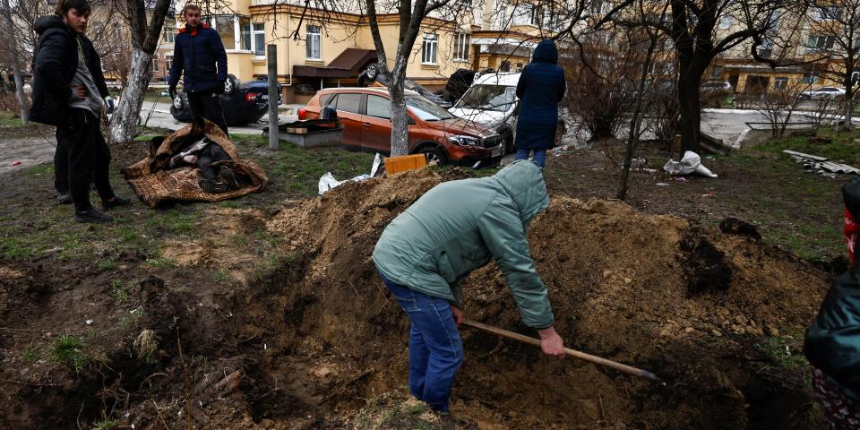 People dig graves in Bucha, Ukraine, on April 5, 2022.