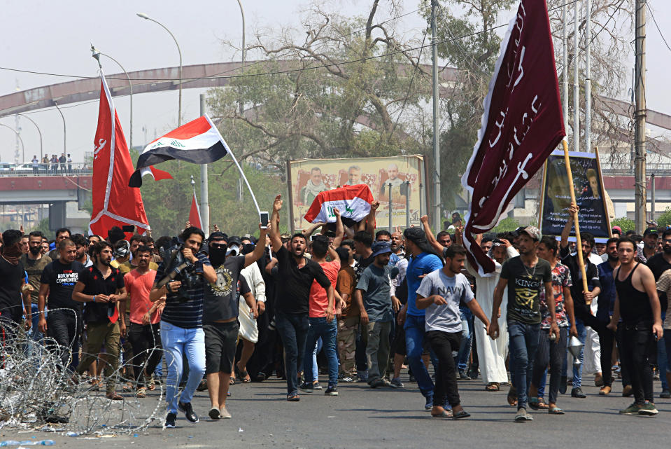 Mourners chant anti government slogans while carrying the Iraqi flag-draped coffin of Mekki Yasser, a protester whose family and activists said he was killed when he participated in a protest last night, during his funeral on Tuesday, Sept. 4, 2018, in Basra, about 340 miles (550 kilometers) southeast of Baghdad, Iraq. (AP Photo/Nabil al-Jurani)