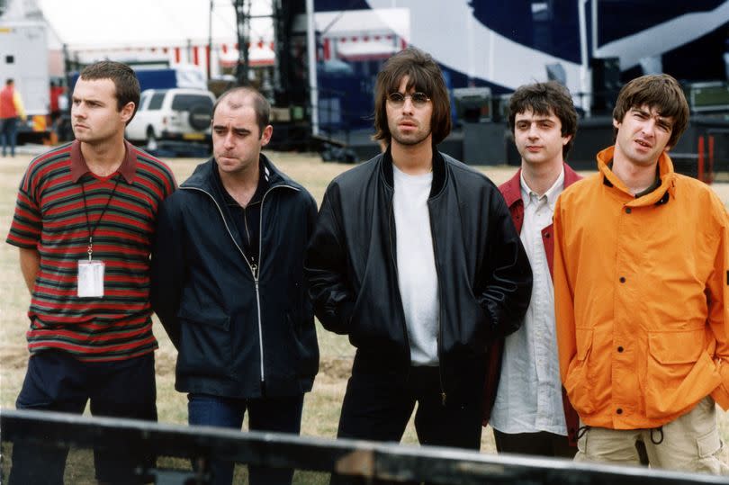 Oasis pictured in 1995 before their legendary Knebworth concert l-r Alan White, Paul "Bonehead" Arthurs, Liam Gallagher, Paul "Guigsy" McGuigan and Noel Gallagher -Credit:PA