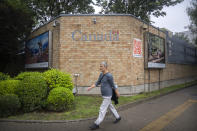 A man walks past the Canadian Embassy in Beijing, Saturday, Sept. 25, 2021. Two Canadians detained in China on spying charges were released from prison and flown out of the country on Friday, Prime Minister Justin Trudeau announced Friday, hours after a top executive of Chinese communications giant Huawei Technologies resolved criminal charges against her in a deal with the U.S. Justice Department. (AP Photo/Mark Schiefelbein)