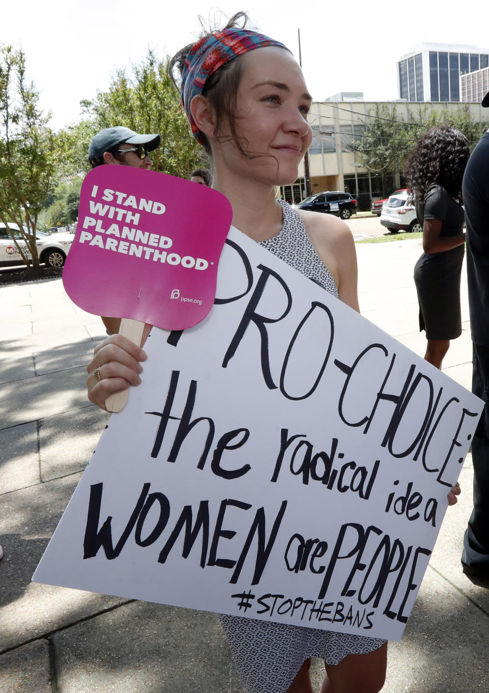 Abbey Williams of Brandon, Miss. holds a sign at the Capitol in Jackson, Miss., voicing her opposition to state legislatures passing abortion bans that prohibit most abortions once a fetal heartbeat can be detected, Tuesday, May 21, 2019. In addition, there are no provisions for rape or incest. Mississippi is among the states that have passed and signed into law such legislation. (AP Photo/Rogelio V. Solis)