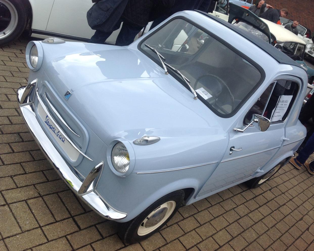 Light blue ACMA Vespa 400 (1957-61) parked on brick road