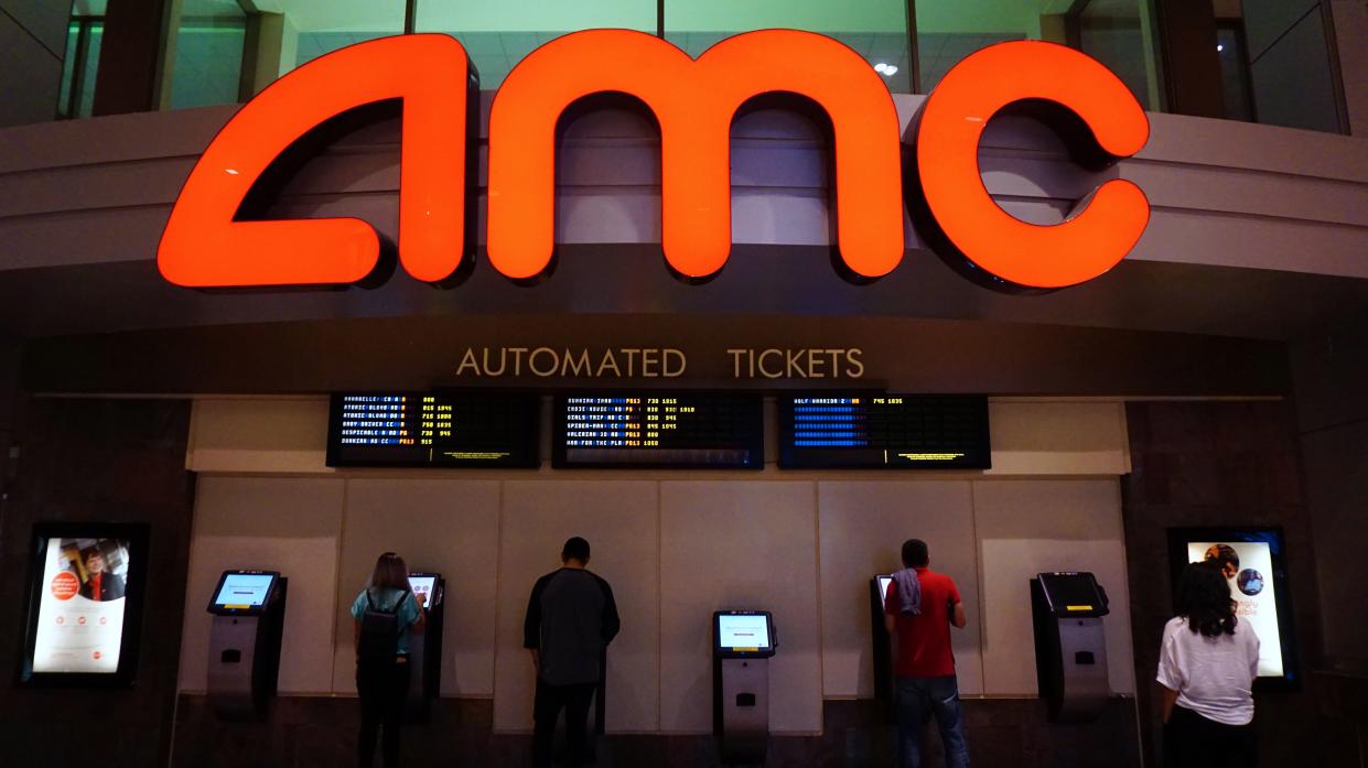 Movie goers purchase automated tickets at an AMC movie theater in Arcadia, California on August 2, 2017. 
AMC Entertainment Holdings, the world's largest movie theater owner, announced a 