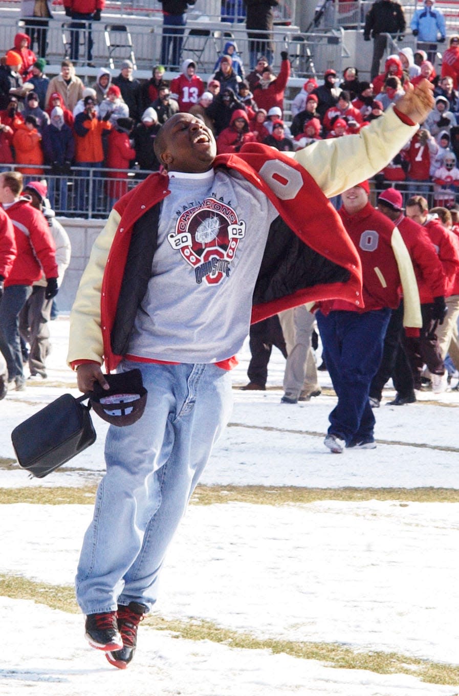 Ohio State's Mike Doss jumps as he enters the field during a celebration Saturday, Jan. 18, 2003, at Ohio Stadium in Columbus. Despite bitter cold temperatures, thousands of Buckeyes fans piled on layers of scarlet and gray clothing to honor Ohio State's national championship.