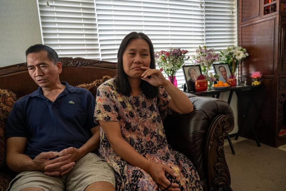 Chelsea Wong, sitting next to her husband Tony, said July 8 she would like to see traffic lights instead of stop signs at the intersection where her father-in-law Sau Voong, 84, died in Natomas Park.  Visibly still shaken, she said “I expected him to live to be 100—this was unexpected,” she said. At left, is a memorial with pictures of both her in-laws;  Sau Voong, who died June 11 and his wife Bat Su who died in March.