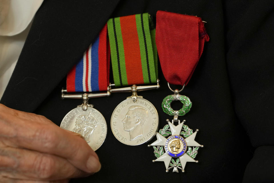 Patricia Owtram who was a serving Wren at the time of D-Day, shows her medals at her home in London, Wednesday, April 10, 2024. D-Day, took place on June 6, 1944, the invasion of the beaches at Normandy in France by Alied forces during World War II. (AP Photo/Kirsty Wigglesworth)