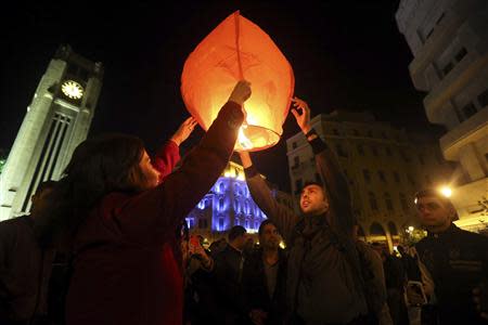 People light a lantern during New Year's celebrations at Star Square in downtown Beirut, December 31, 2013. REUTERS/Hassan Shaaban