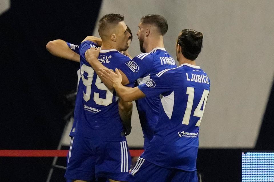 Mislav Orsic, left, celebrates with his team-mates after scoring Dinamo’s winner (Darko Bandic/AP) (AP)