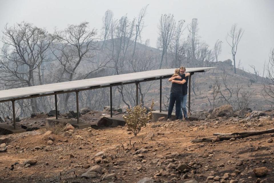 Linda and Dennis Fischer hug at their home in Forest Ranch on Wednesday. “I’ve lived up here 30 years, and you’re always sort of ready for this in the back of your head,” Dennis Fischer said. “And it doesn’t make it that much easier. Thirty years, same home.”