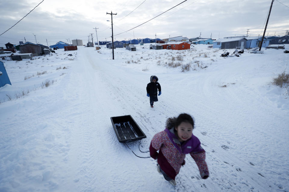 Children play in the snow Saturday, Jan. 18, 2020, in Toksook Bay, Alaska. The first Americans to be counted in the 2020 Census starting Tuesday, Jan. 21, live in this Bering Sea coastal village. The Census traditionally begins earlier in Alaska than the rest of the nation because frozen ground allows easier access for Census workers, and rural Alaska will scatter with the spring thaw to traditional hunting and fishing grounds. (AP Photo/Gregory Bull)