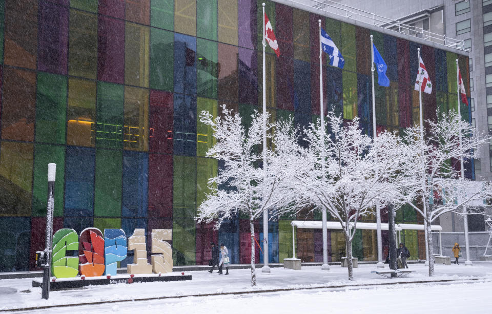 FILE - Delegates arrive at the convention centre at the COP15 UN conference on biodiversity during a snowfall in Montreal, Friday, Dec. 16, 2022. After a historic biodiversity agreement was reached, countries now face pressure to deliver on the promises. The most significant part of the global biodiversity framework is a commitment to protect 30% of land and water considered important for biodiversity by 2030. (Paul Chiasson/The Canadian Press via AP, File)