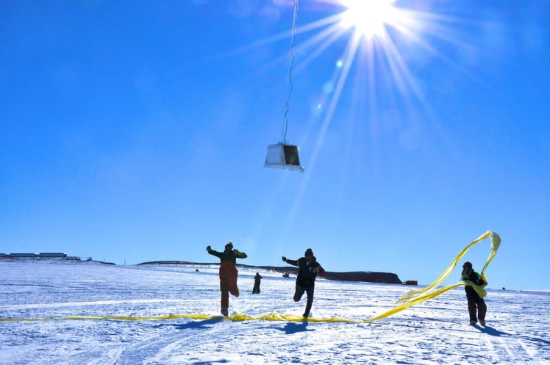 Researchers run under the payload as a balloon first takes flight at the SANAE IV research station in Antarctica. On December 1, 1959, the United States and the Soviet Union signed a treaty banning military activity on Antarctica, reserving the continent for scientific research. File Photo courtesy of NASA