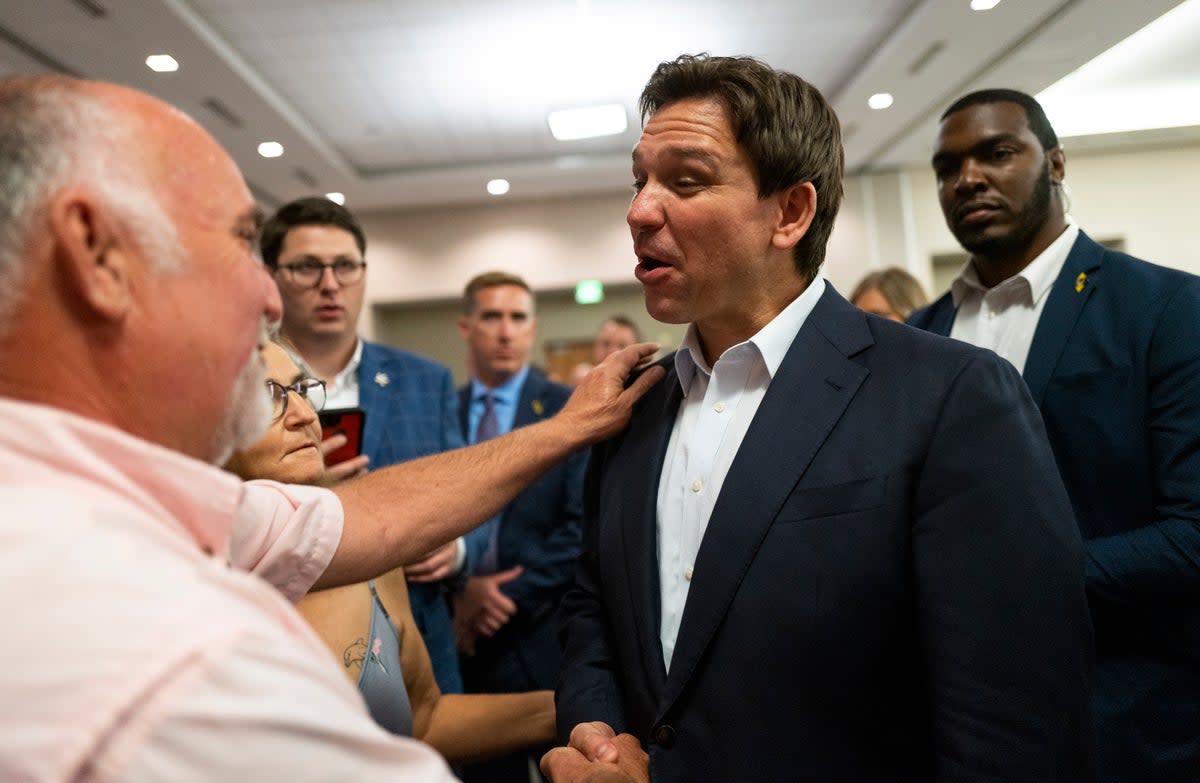 Florida governor Ron DeSantis speaks with attendees during an Iowa GOP reception on 13 May 2023 in Cedar Rapids, Iowa (Getty Images)