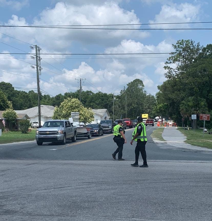 Police direct traffic Sunday afternoon at the corner of South Main Street and Poe Springs Road, following the closure of Ginnie Springs Outdoors.