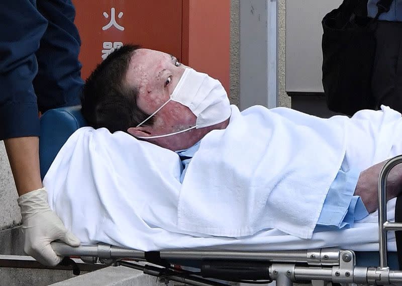 Shinji Aoba, a suspected arsonist who is suspected of killing 36 people at Kyoto Animation in July 2019, is seen on a stretcher as he is carried to Fushimi police station after being arrested in Kyoto, Japan