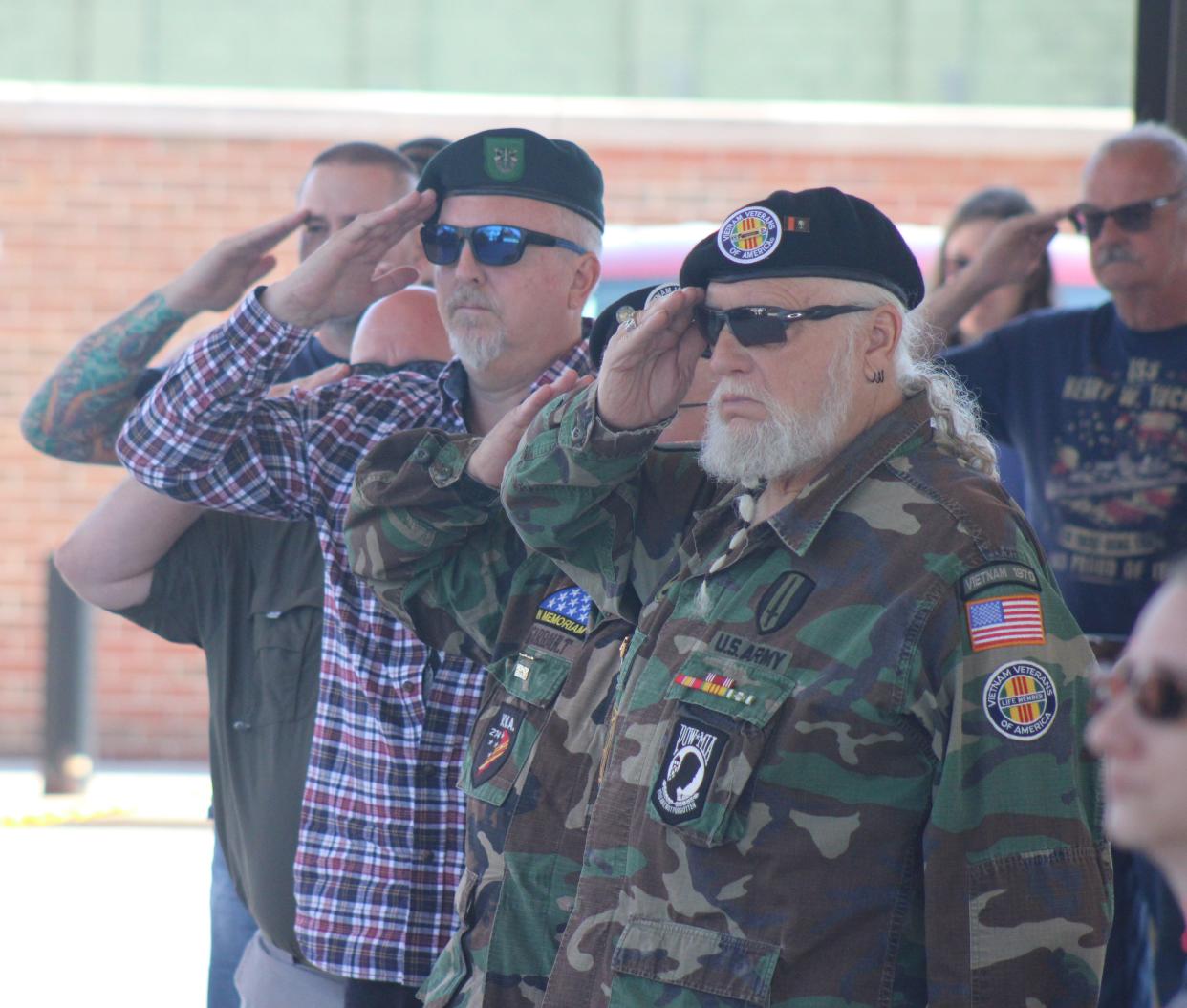 Cheboygan County veterans give a salute during a Memorial Day ceremony held at Festival Square in Cheboygan on Monday.