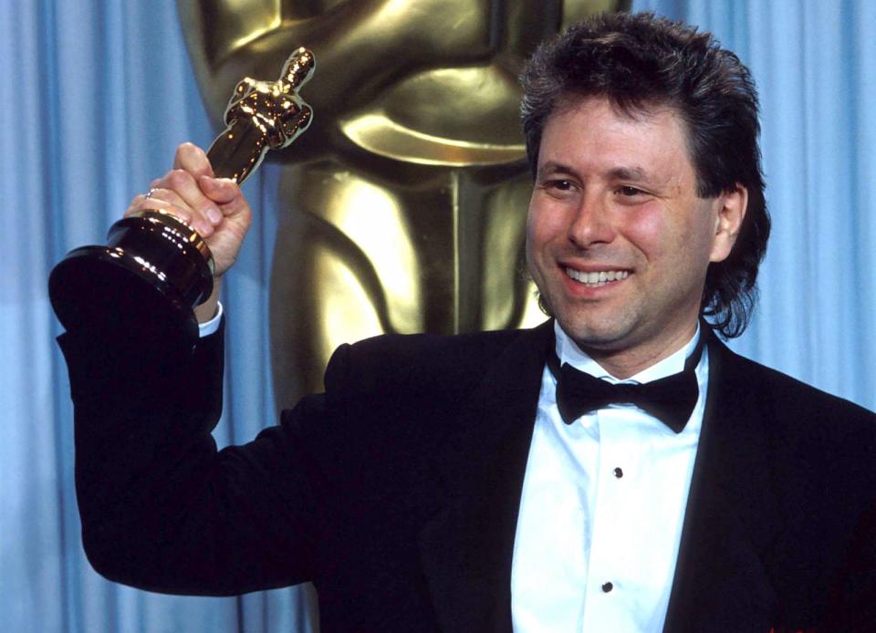 PHOTO: Alan Menken holds the Oscar he received for Best Original Score in 'The Little Mermaid' during the 62nd Academy Awards ceremony Mar. 26, 1990, in Los Angeles. (John T. Barr/Getty Images)