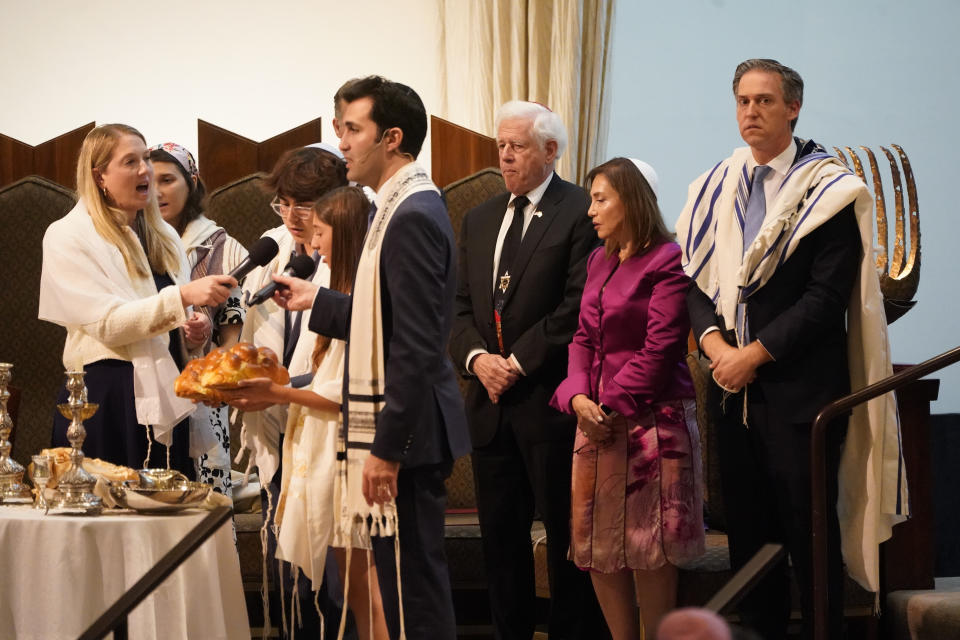 Worshippers receive blessings over Shabbat at The Sinai Temple in Los Angeles on Saturday, Oct. 14, 2023. The temple's worshippers, the majority of whom have family in Israel, were on edge after recent pro-Palestine rallies elsewhere in Los Angeles. The Shabbat service, themed "Sinai Temple Stands with Israel," featured prayers and songs for Israel, including the Israeli national anthem, to conclude the service as several people in the audience waved small Israeli flags. (AP Photo/Damian Dovarganes)