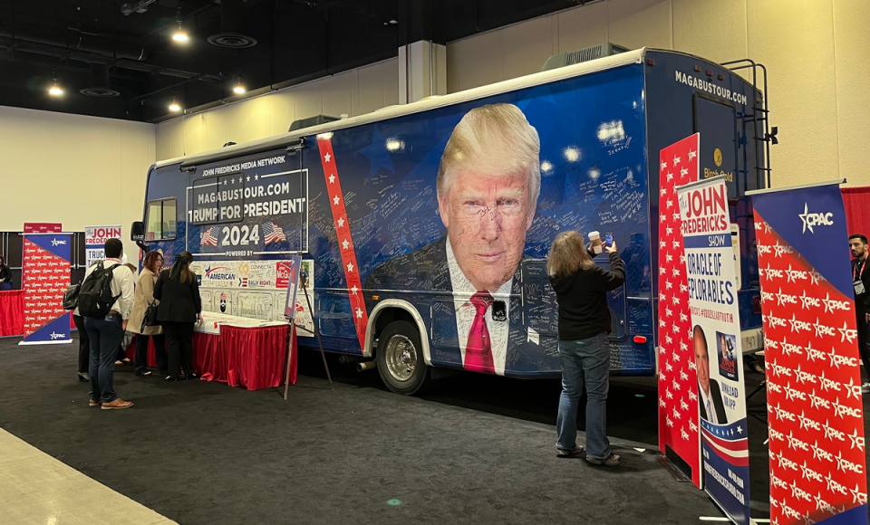 Radio host John Fredericks parked his bus in the exhibition hall for attendees to sign (Gustaf Kilander / The Independent)