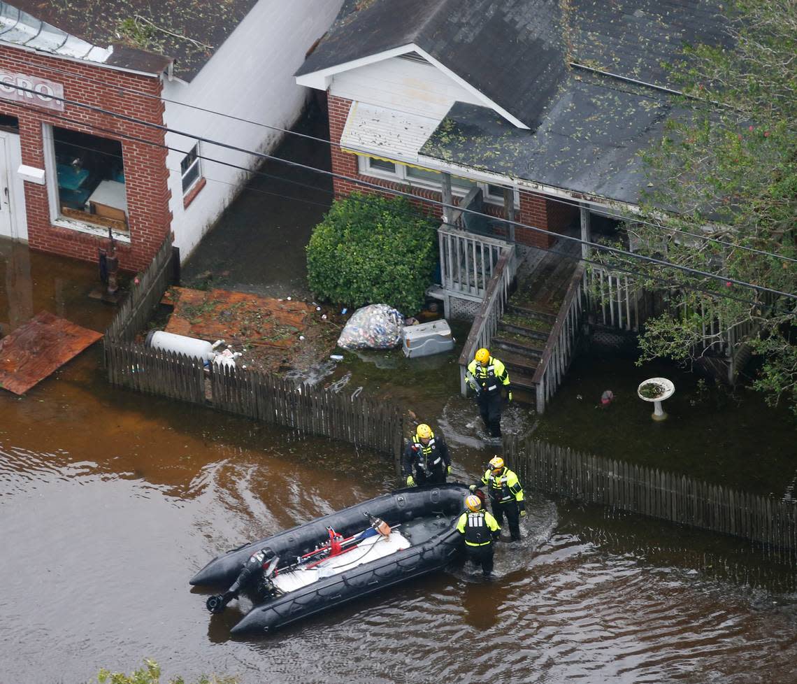 Rescue personnel use a small boat as they go house to house checking for flood victims from Florence, now a tropical storm, in New Bern, NC., Saturday, Sept. 15, 2018.