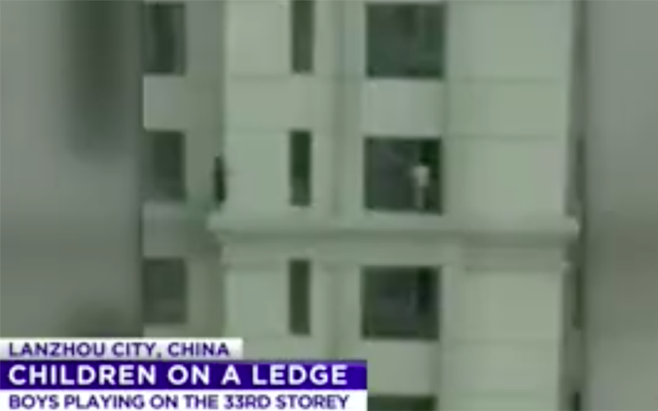 Horrified witnesses filmed the boys playing on the ledge of a high-rise in China. Source: 7 News