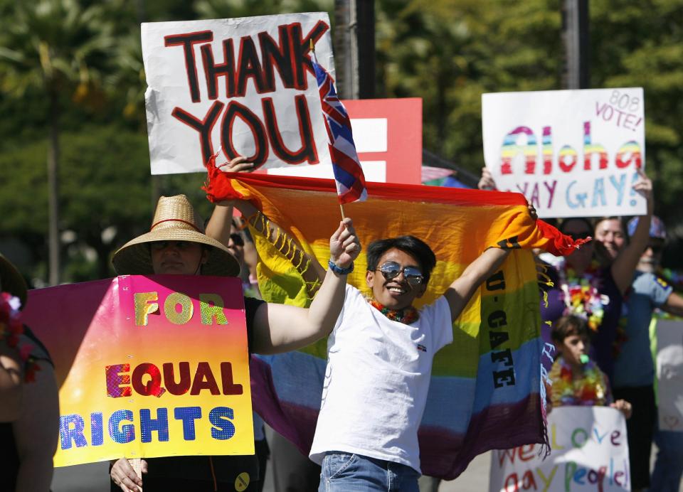 Colin Porter waves a flag with other supporters of same-sex marriage as they celebrate while the Hawaii State Senate convenes to approve the bill to legalize same-sex marriage in the state of Hawaii, in Honolulu