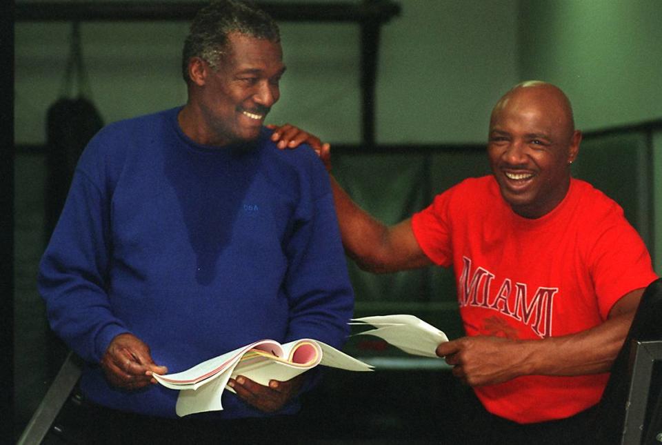 Tommy Lane, left, and “Marvelous” Marvin Hagler, go over their lines while on location at the Hialeah Police Department’s Gym during the shooting of the movie “Virtual Weapon” in 1996.