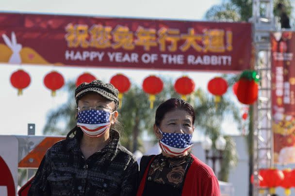 PHOTO: People look on from a street near the location of a shooting that took place during a Chinese Lunar New Year celebration, in Monterey Park, Calif., Jan. 22, 2023. (Mike Blake/Reuters)