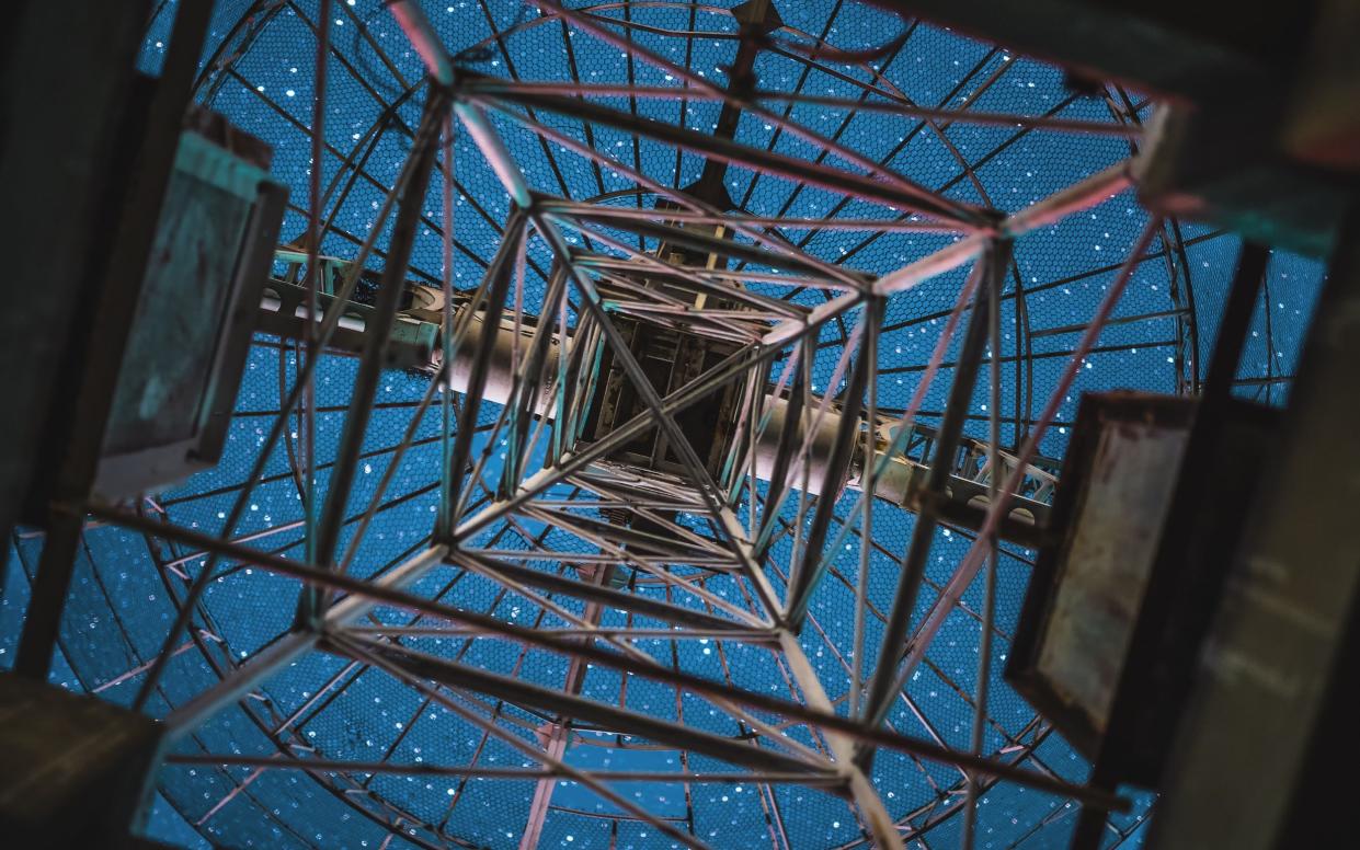 Looking at starry sky from below a radio telescope antenna