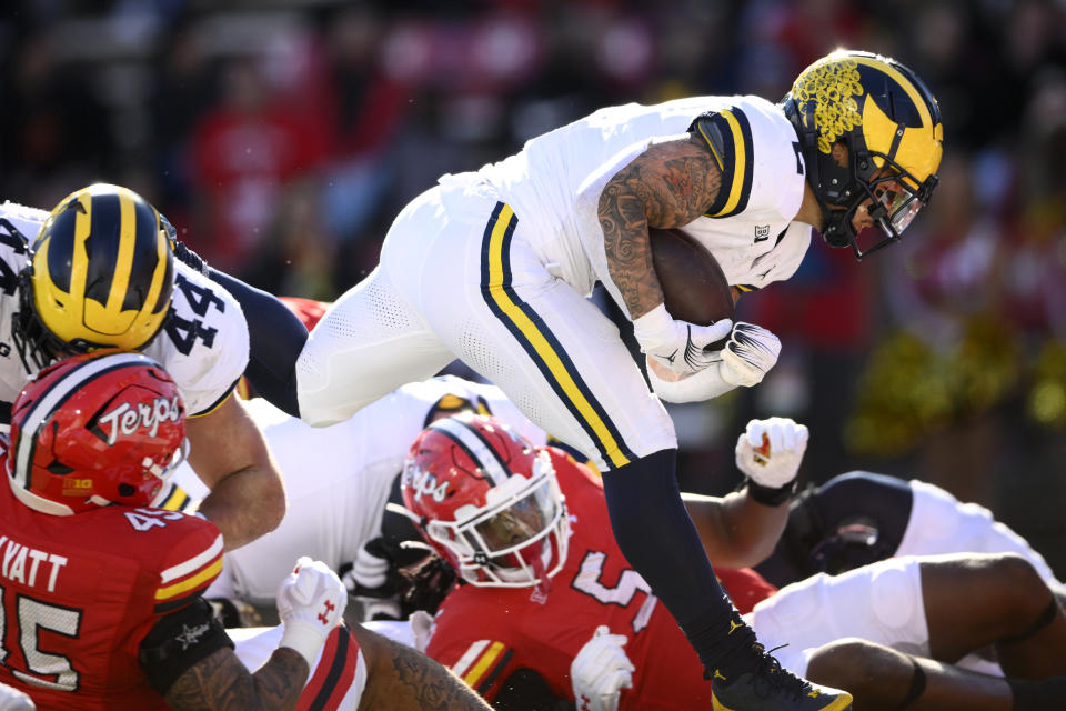 Michigan running back Blake Corum (2) runs in for a touchdown during the first half of an NCAA college football game against Maryland, Saturday, Nov. 18, 2023, in College Park, Md. (AP Photo/Nick Wass)