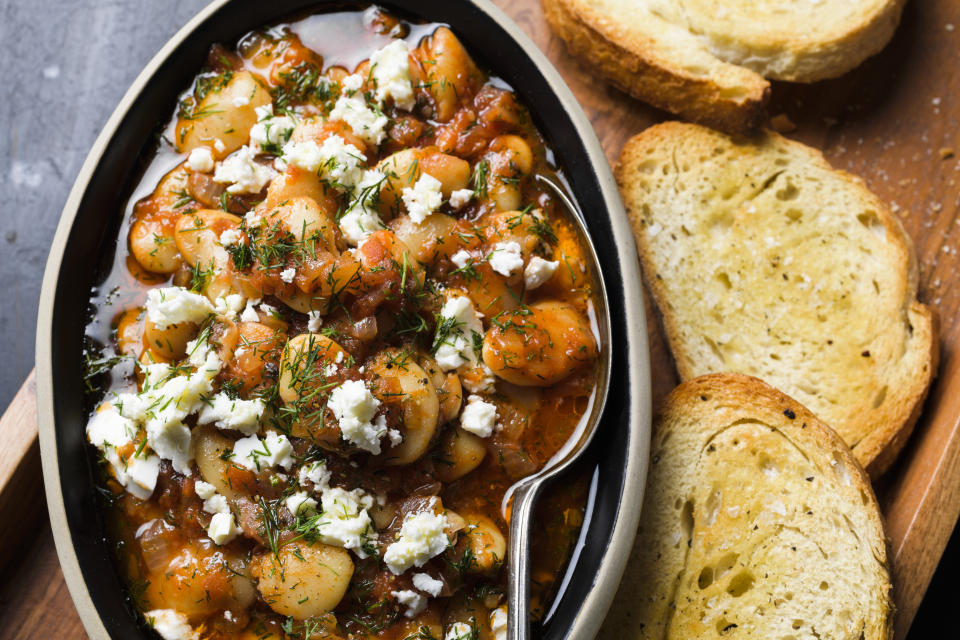 This image released by Milk Street shows a recipe for Butter Beans in Tomato Sauce. (Milk Street via AP)