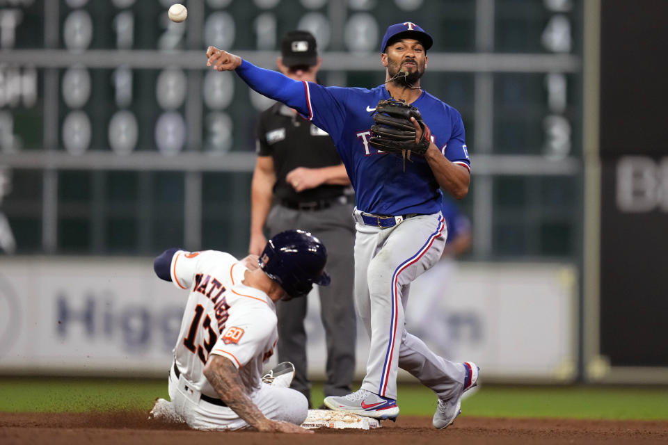 Texas Rangers second baseman Marcus Semien (2), right, attempts a double play over Houston Astros' J.J. Matijevic during the fourth inning of a baseball game, Tuesday, Sept. 6, 2022, in Houston. Chas McCormick was safe at first. (AP Photo/Eric Christian Smith)