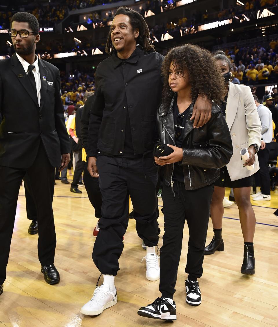 Jay-Z and daughter, Blue Ivy Carter exits after the game against the Boston Celtics and the the Golden State Warriors