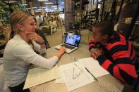 <p>(L-R) Brianne Theisen, Canadian Heptathlete, and her fiance Ashton Eaton of the USA Track and Field Team discuss flowers for their upcoming wedding with a florist on April 11, 2013 in Eugene, Oregon. Eaton is the reigning Olympic gold medalist and world record holder in the decathlon. (Photo by Doug Pensinger/Getty Images) </p>