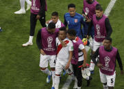 <p>Distraught: Cristian Cueva is consoled by his teammates as he leaves the field after Peru’s defeat. (AP) </p>