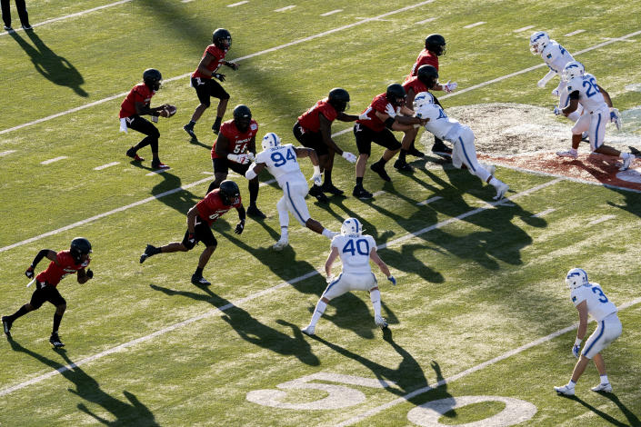 Louisville quarterback Malik Cunningham (3) takes the snap during the first half of the First Responder Bowl NCAA college football game against Air Force Tuesday, Dec. 28, 2021, in Dallas. (AP Photo/Jeffrey McWhorter)
